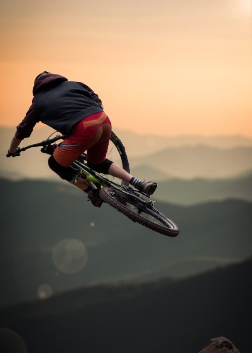 Photo by Adrien Vajas man in blue jacket riding bicycle
